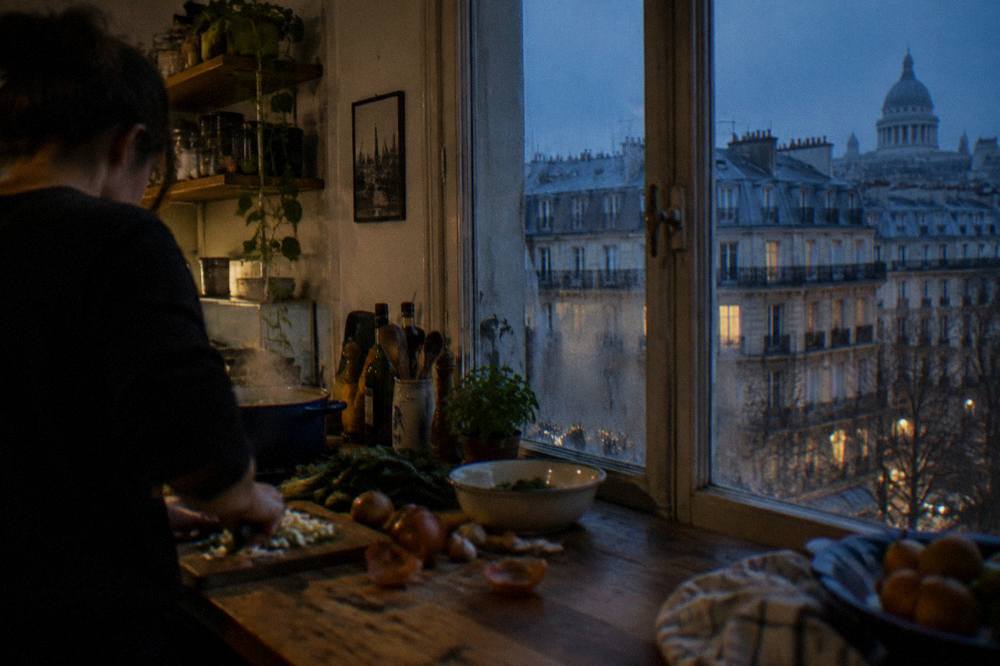 Cook preparing fresh vegetables on a wooden kitchen counter
