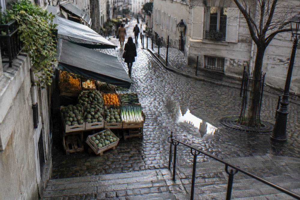 Market stall with fresh produce displayed in wooden crates