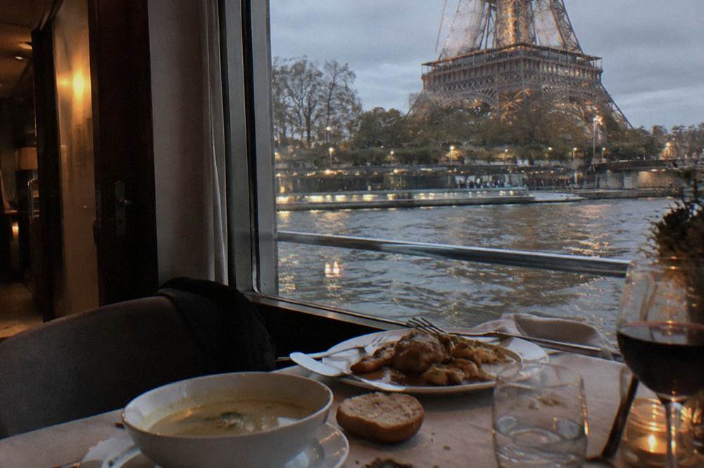 A plated three-course meal on a dining table inside a cruise boat