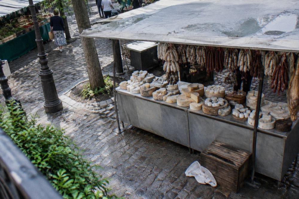 Cheese and charcuterie display in a small Parisian food shop