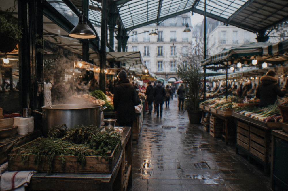 Covered market hall with food stalls under an iron and glass roof