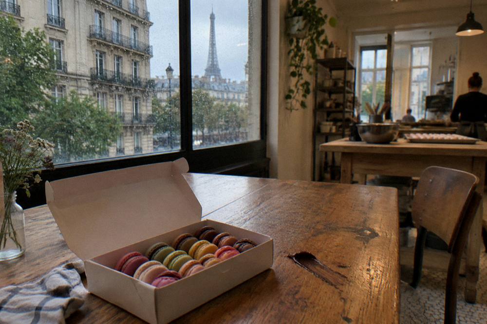 A box of colorful handmade macarons packed for taking home from a class