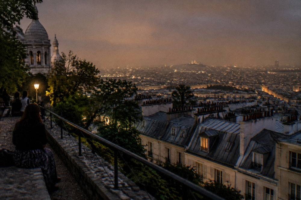 Evening view over Paris rooftops from the top of a hill neighbourhood